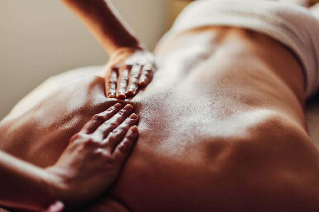 Close up,Of,Masseur's,Hands,And,A,Client's,Back