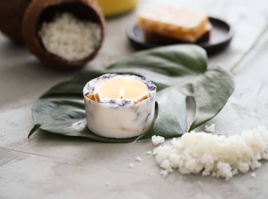 A close-up of rising incense smoke next to a "Gentle Anxiety Relief" sign and balanced river stones