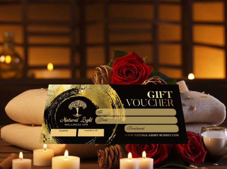A gift voucher for Natural Light Wellness Spa displayed on towels with roses and lit candles in a relaxing spa setting.